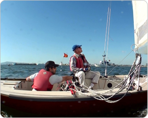 Two men in a boat on the water.