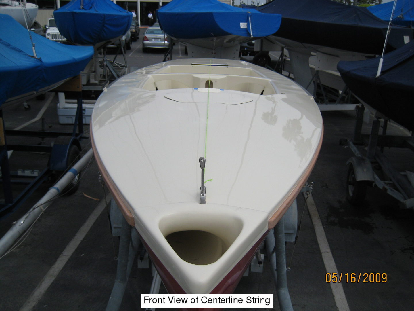 A boat is parked in the dock with other boats.