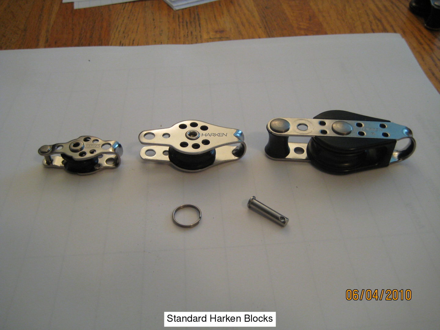 A group of three different sized metal parts.