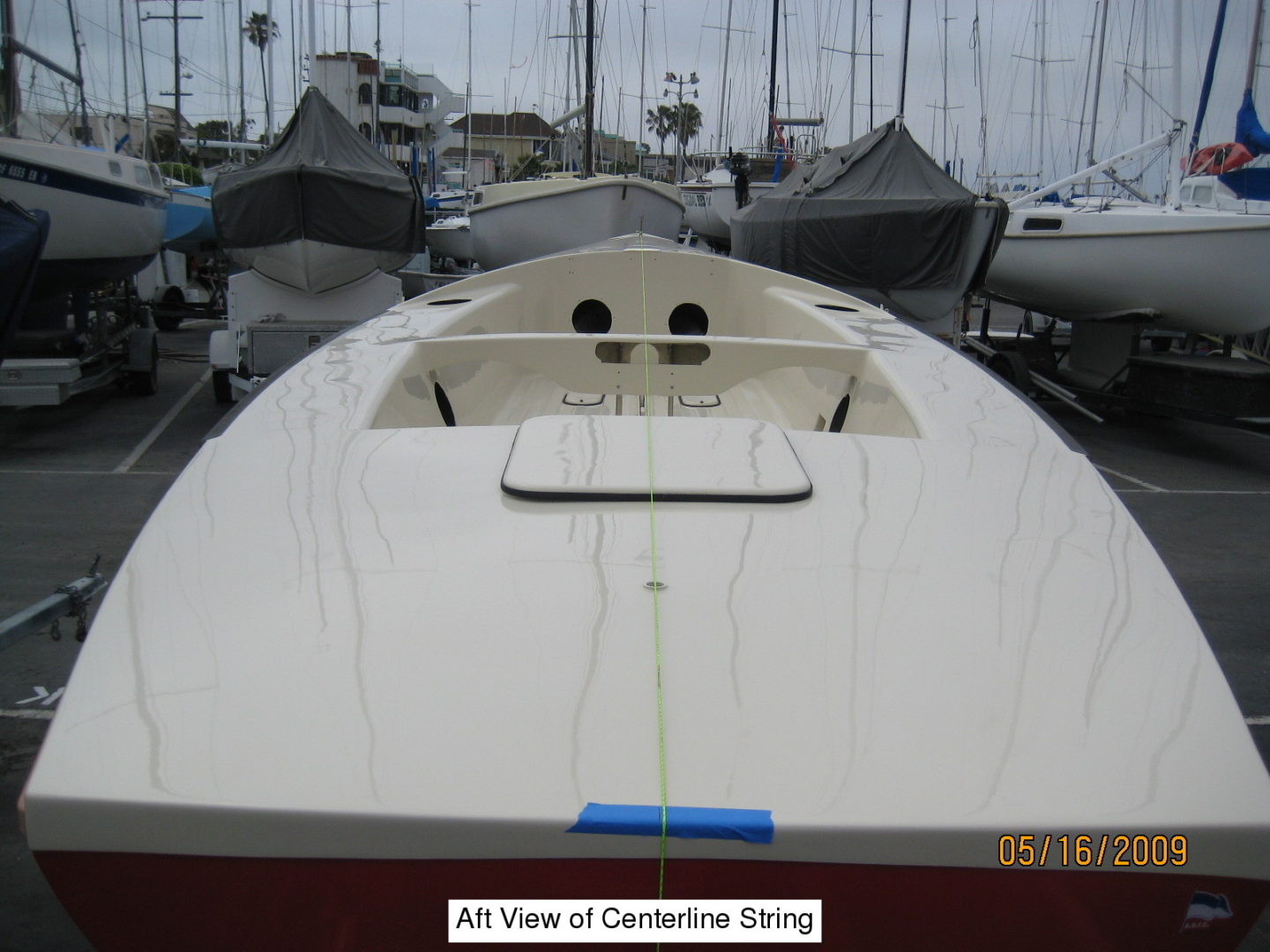 A boat is parked in the dock with other boats.