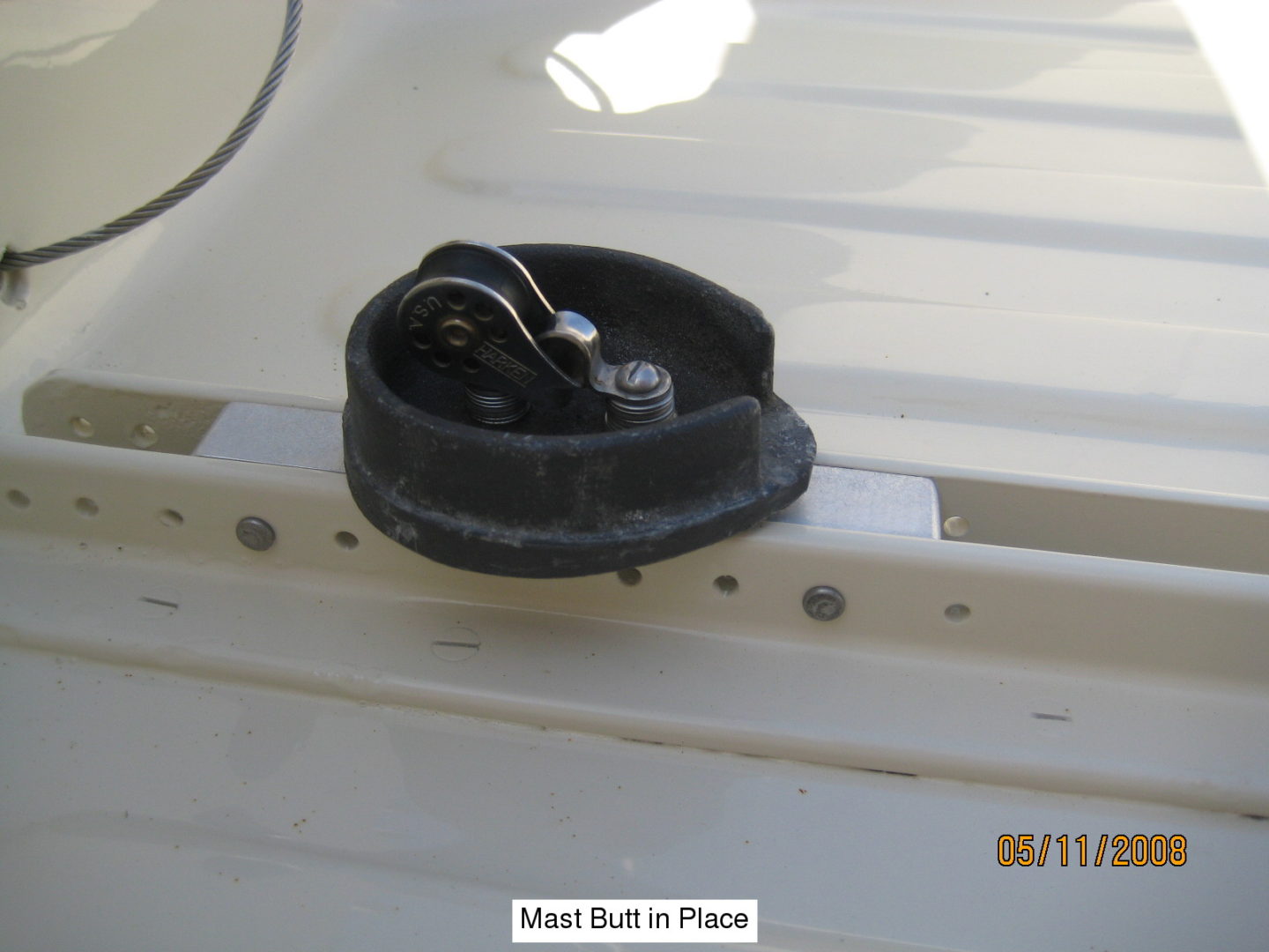 A black container sitting on top of a white boat.