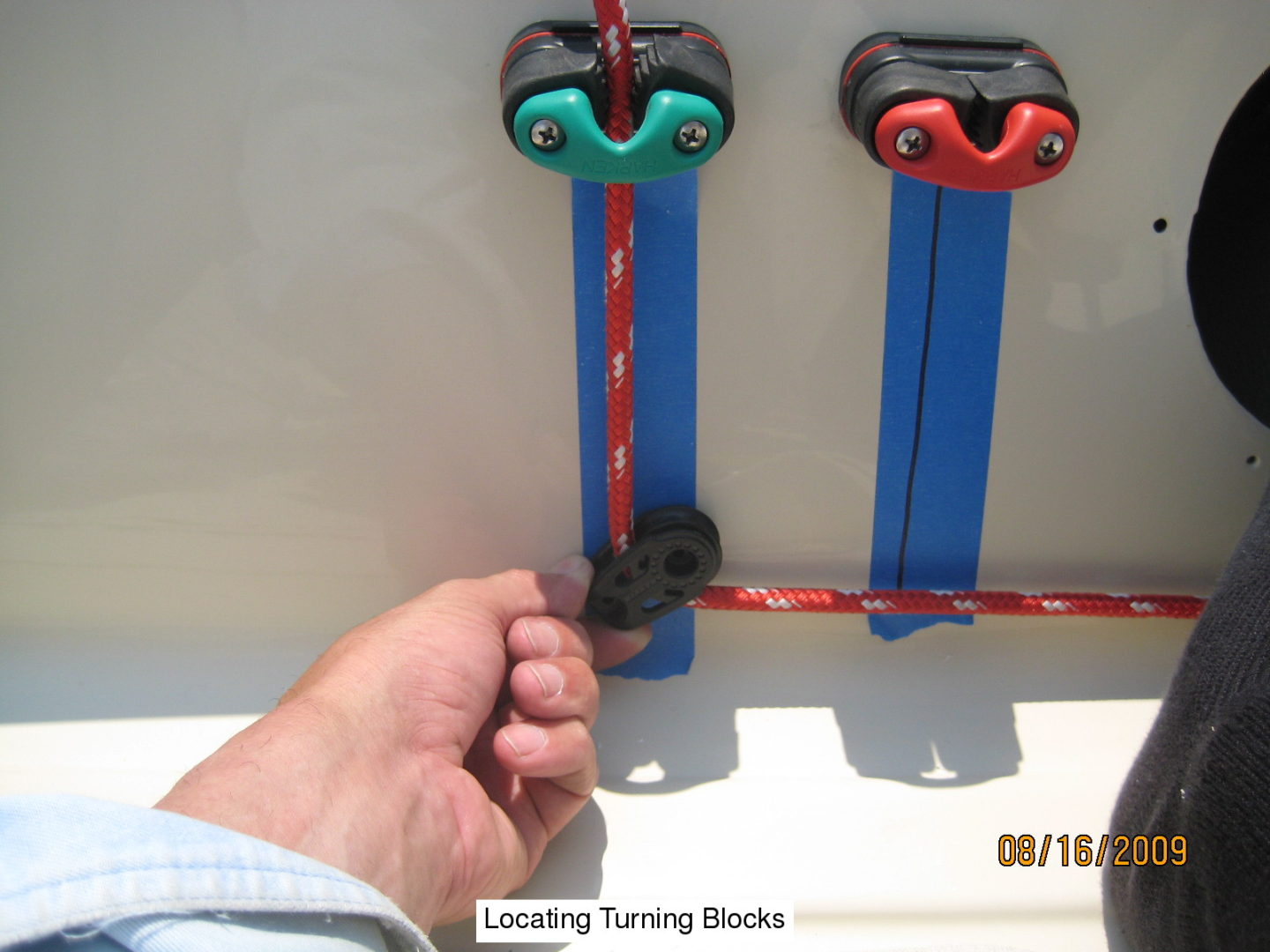 A hand holding onto the handle of a toy train.