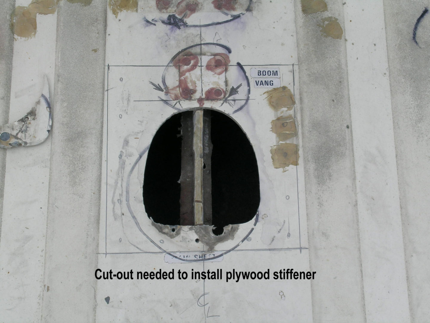 A hole in the wall with instructions for installing plywood stiffener.