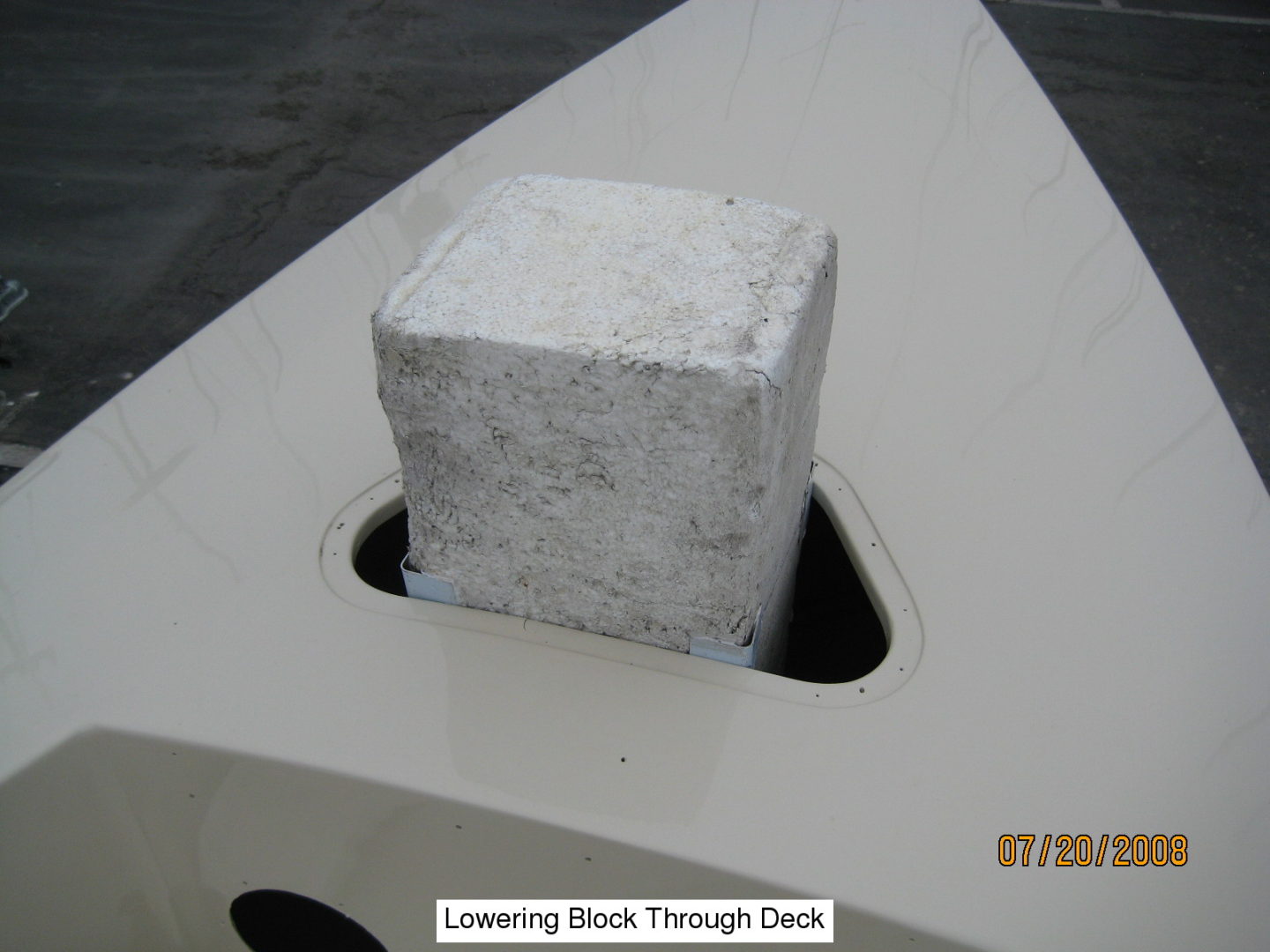 A block of concrete sitting on top of a boat.