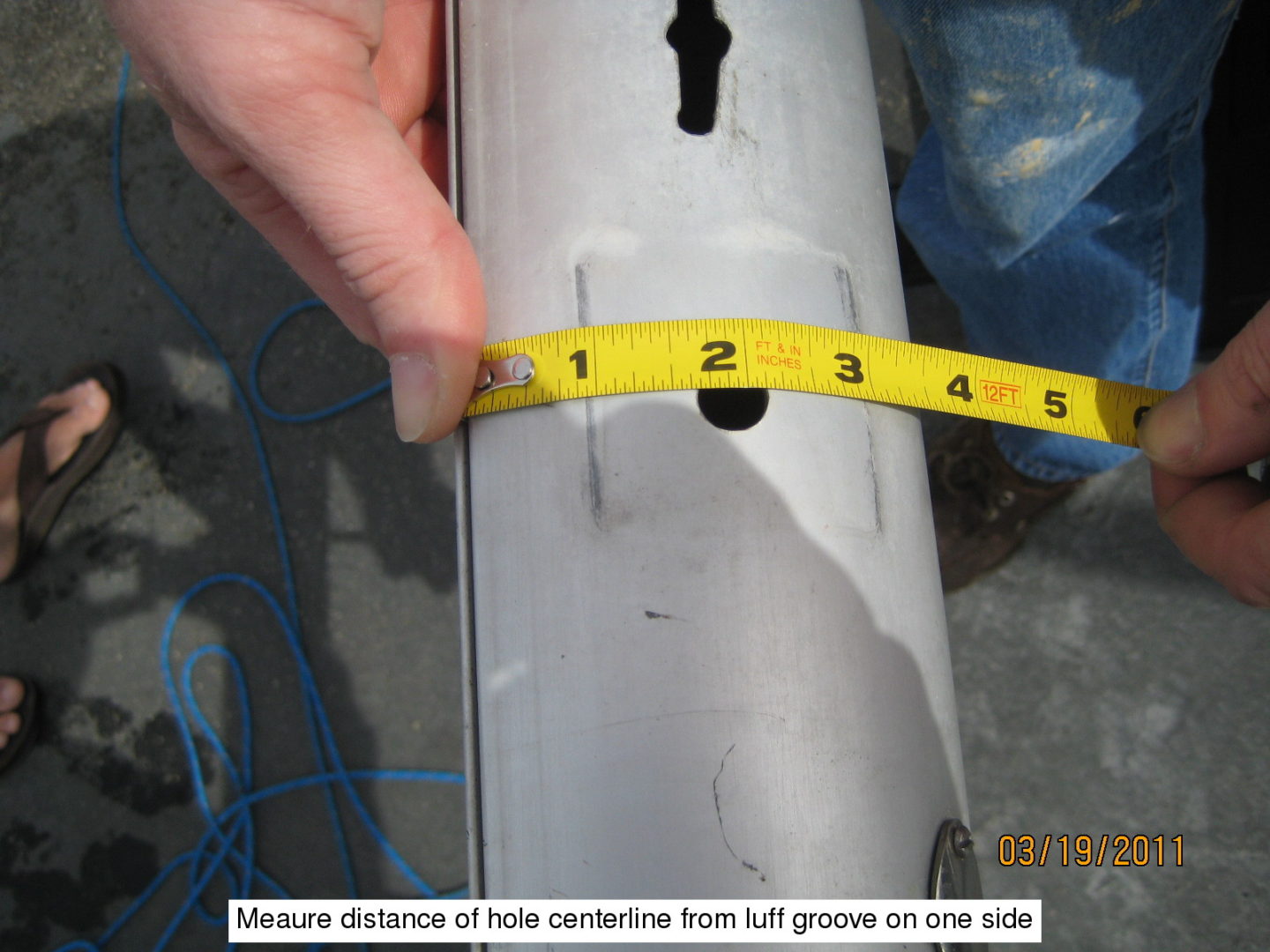 A person measuring the distance of hole center from left groove on one side.