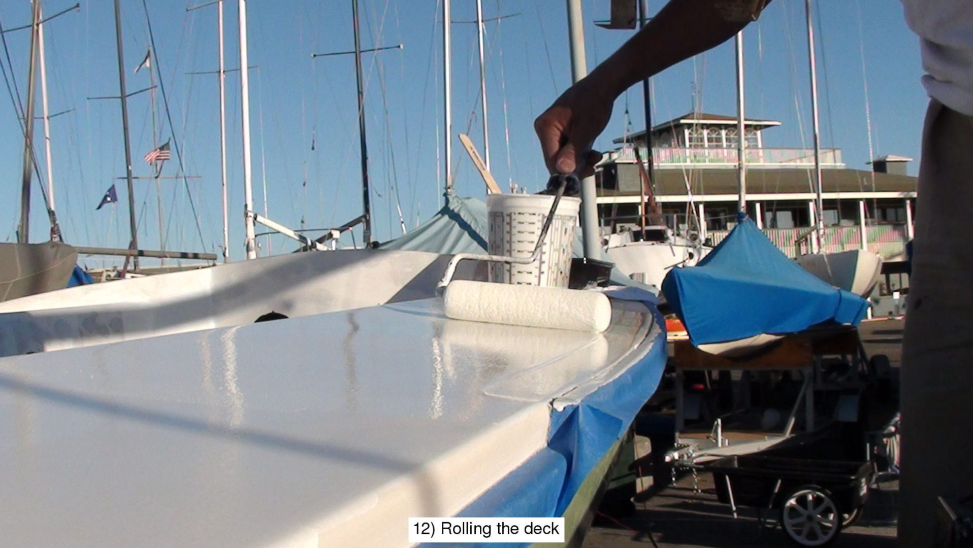 A person painting the deck of a boat.