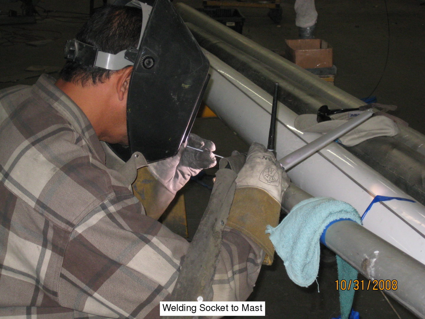 A man working on a metal pipe.