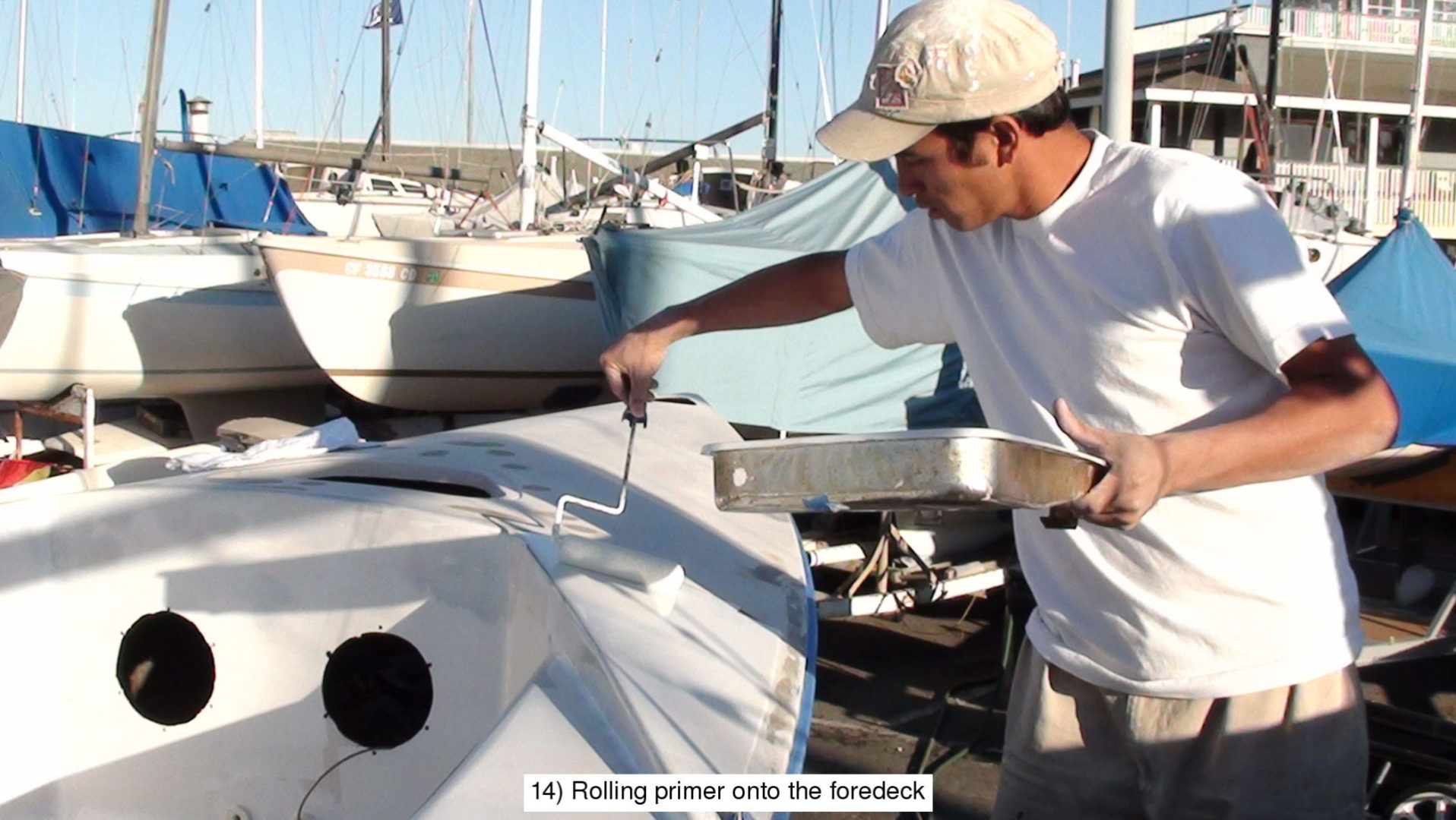 A man painting the hull of a boat.