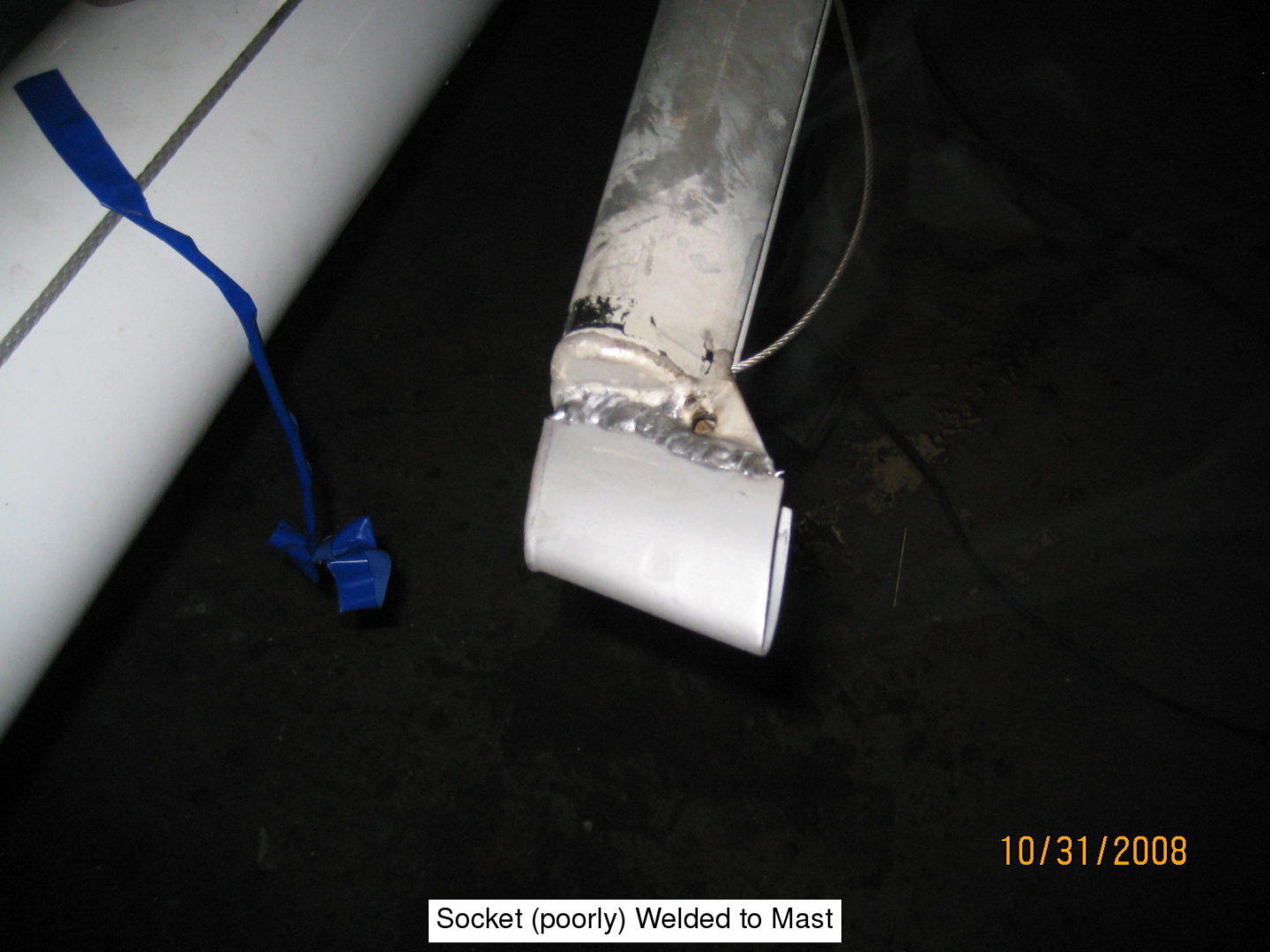 A white pipe with a blue cord attached to it.