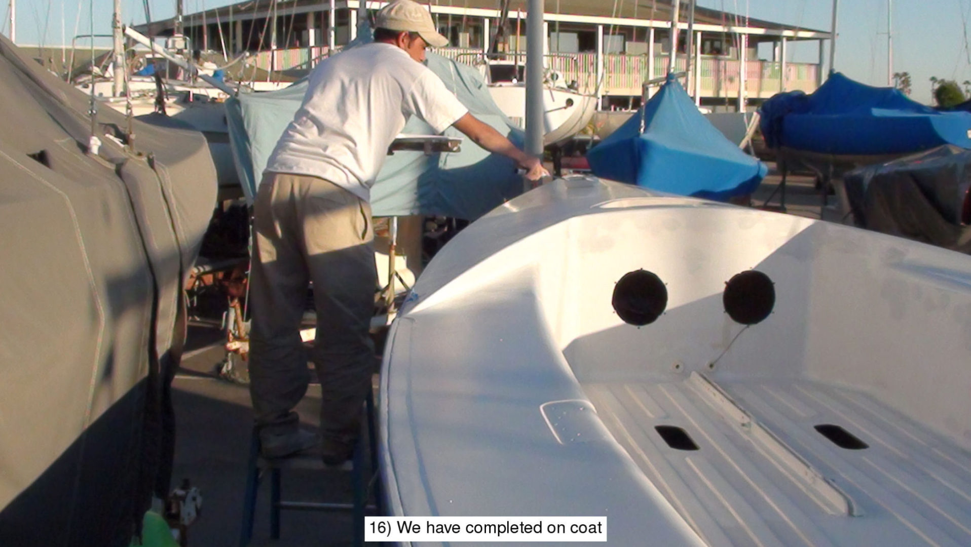 A man working on the hull of a boat.