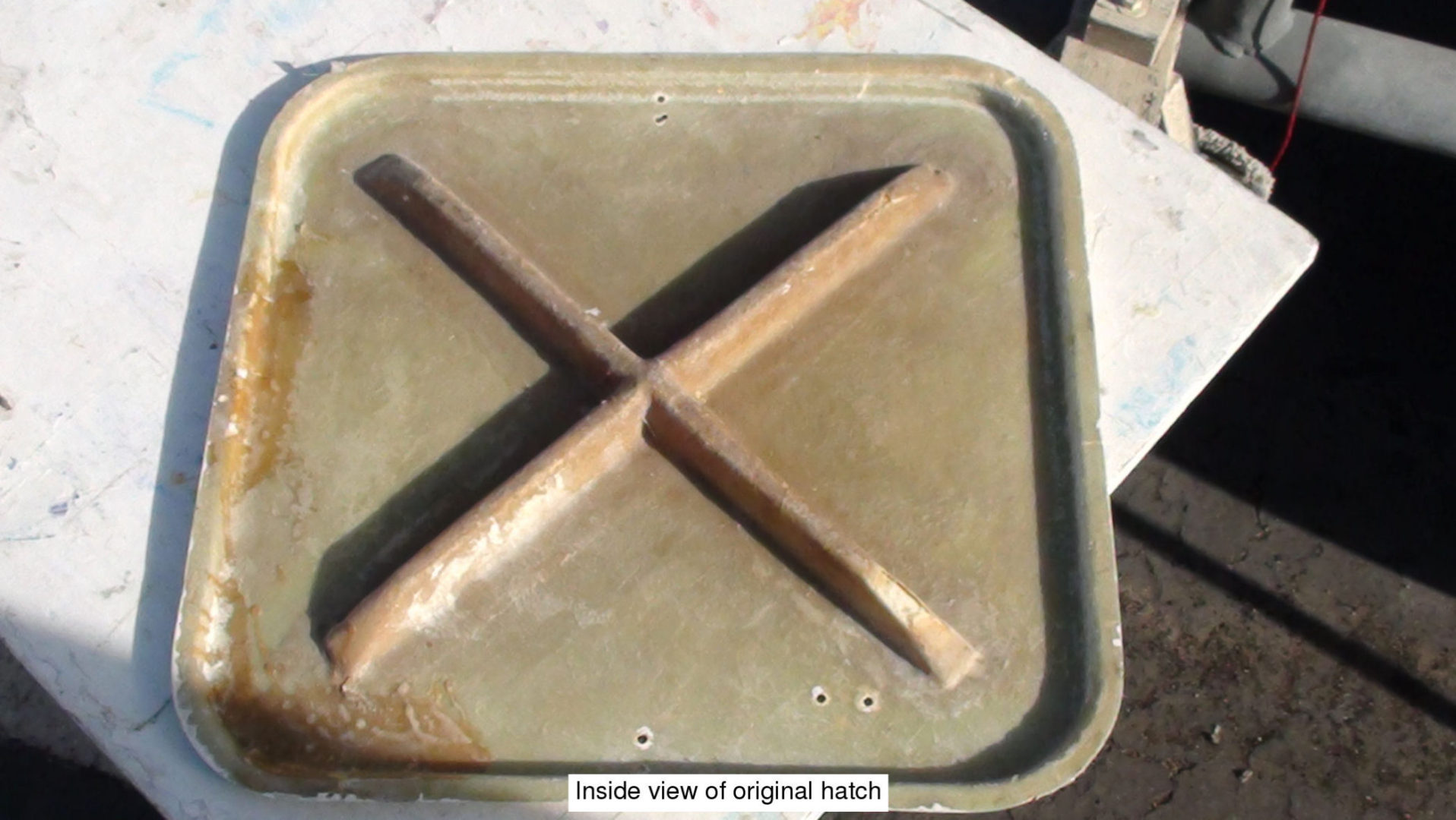 A metal pan with some wood sticks on top of it