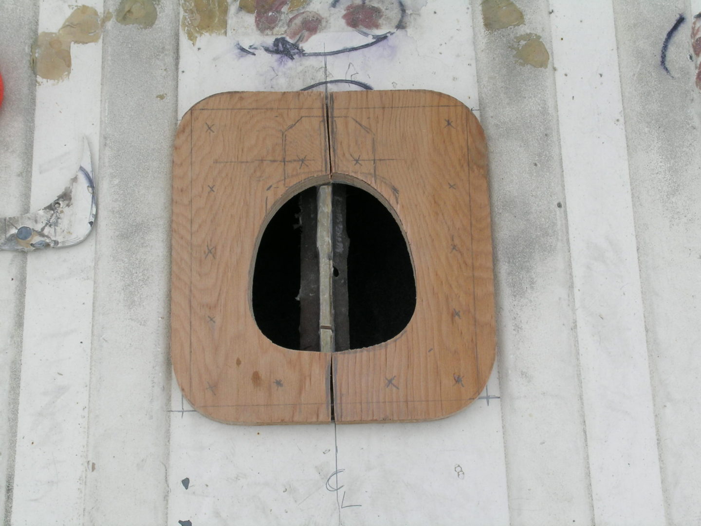 A wooden hatch on the side of a boat.