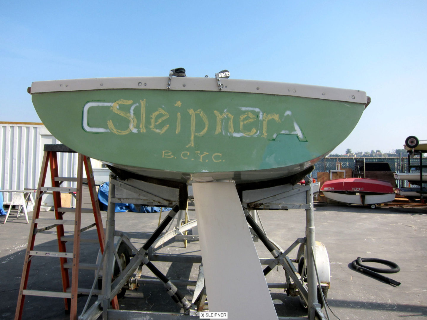 A boat sitting on top of the ground.