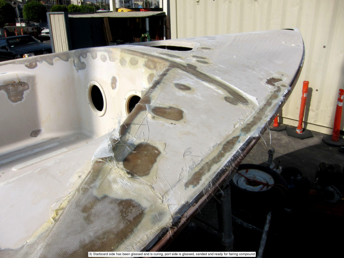 A boat is being worked on by the owner.