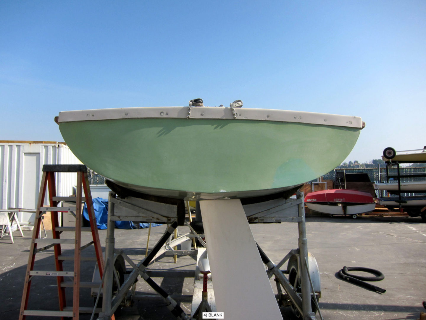 A boat is being painted green and ready for repairs.