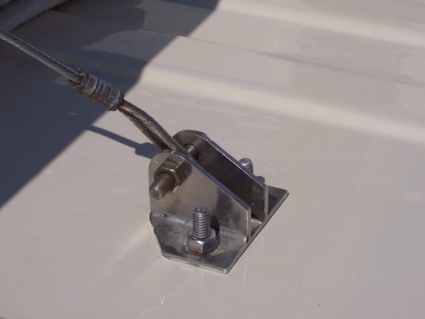 A metal device attached to the side of a boat.