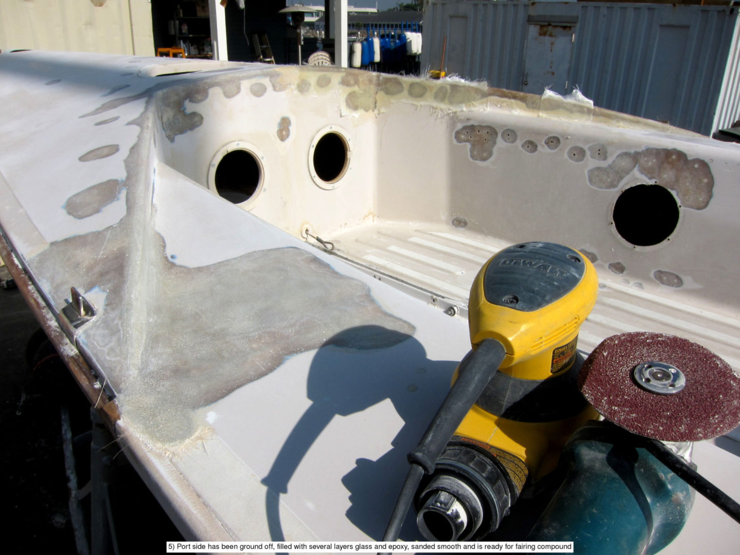 A yellow and black handle is on the side of a boat.