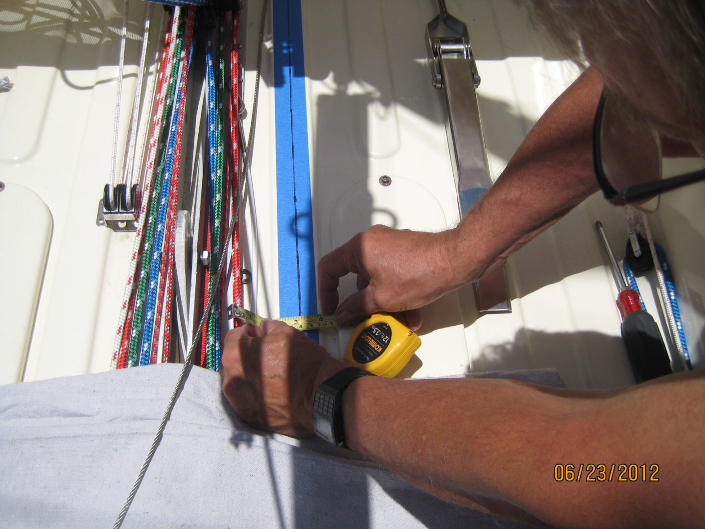 A person using a pair of scissors to cut the fabric.