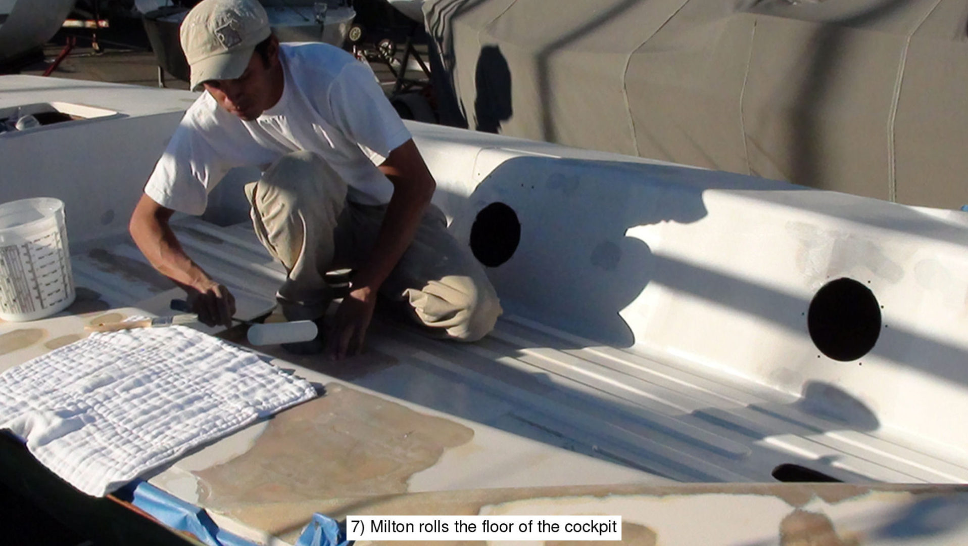 A man working on the roof of his boat.