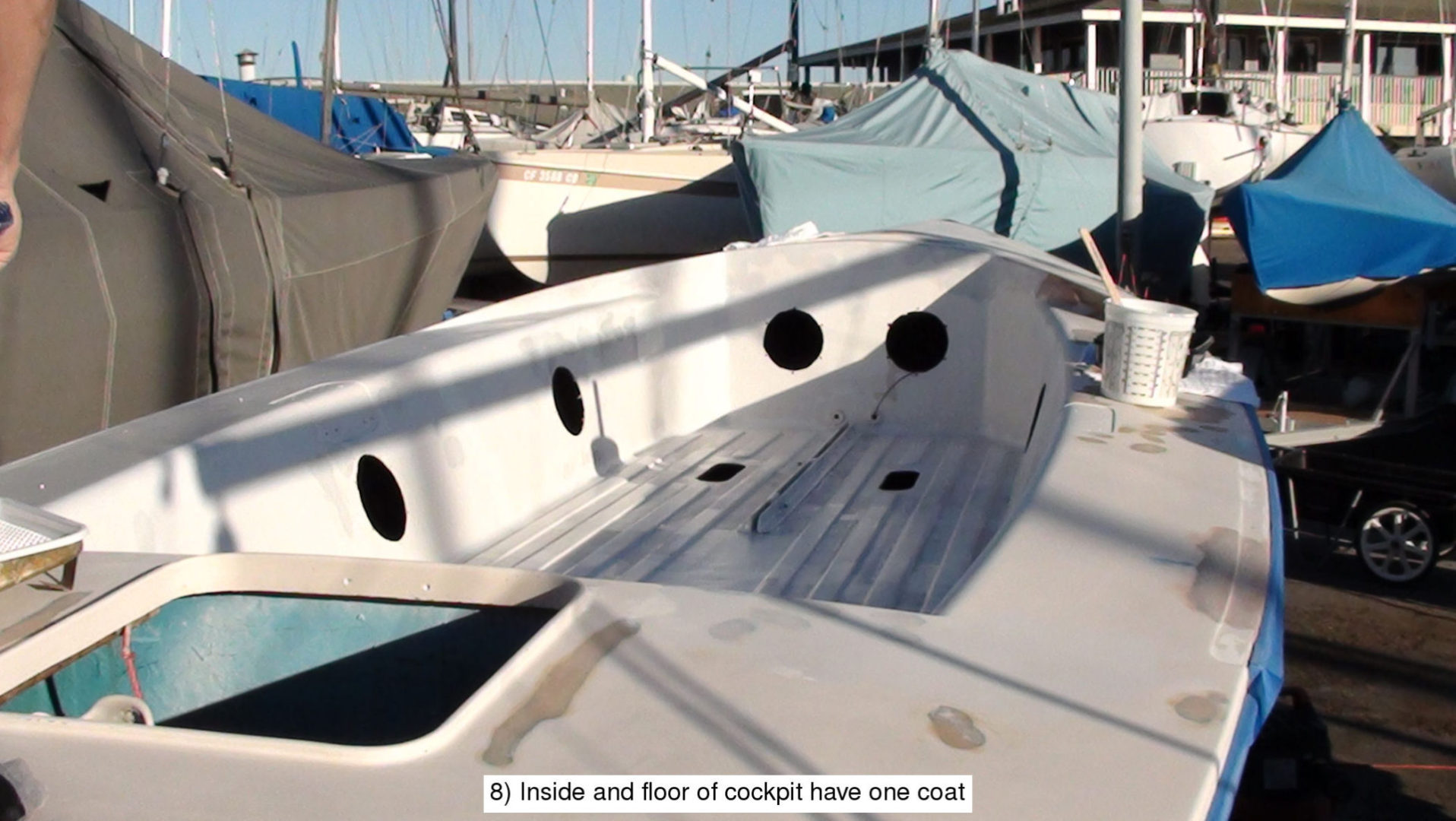 A boat is parked in the dock with other boats.