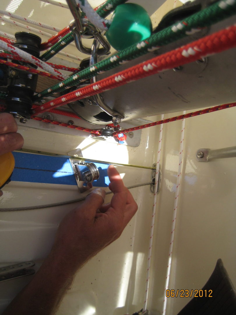 A person working on wires in an electrical room.