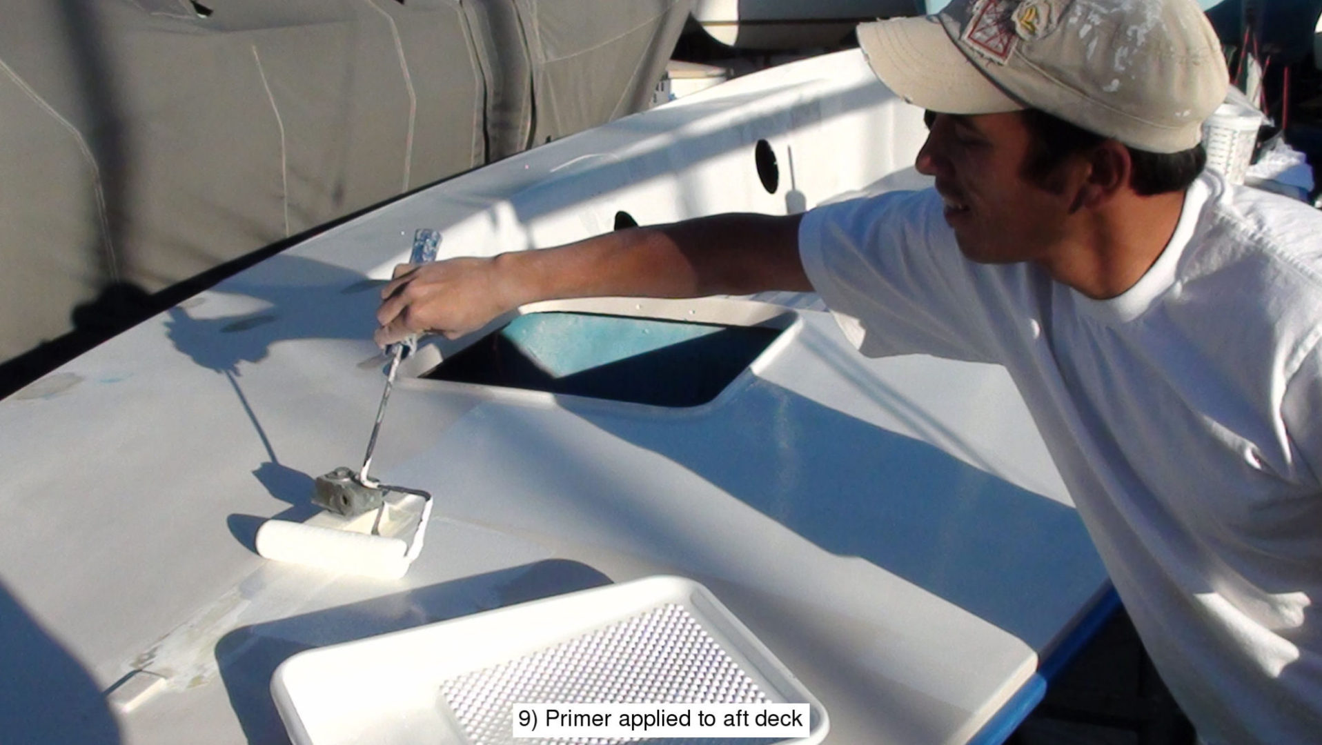 A man is working on the deck of his boat.