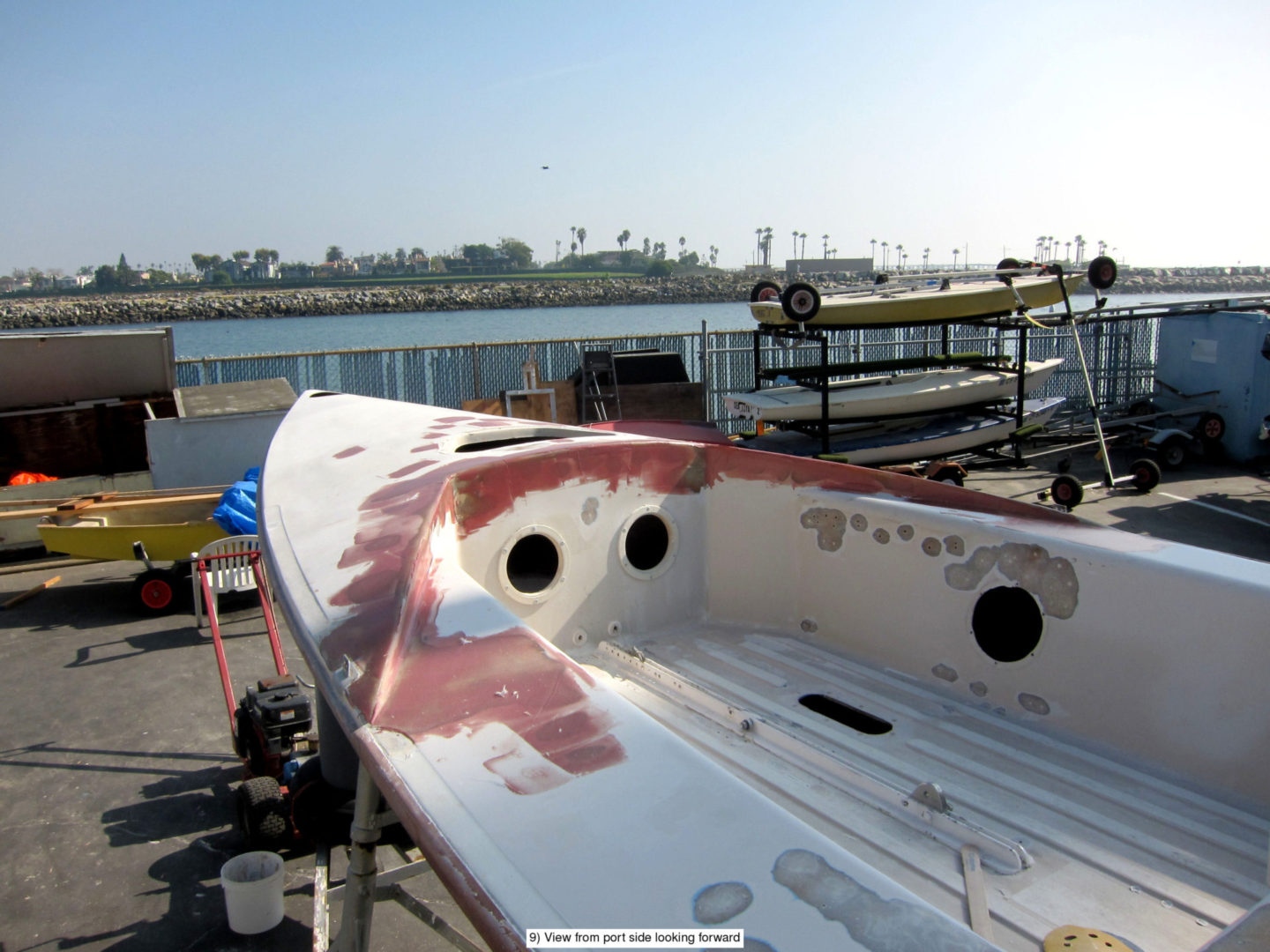 A boat is sitting on the dock and has been painted.