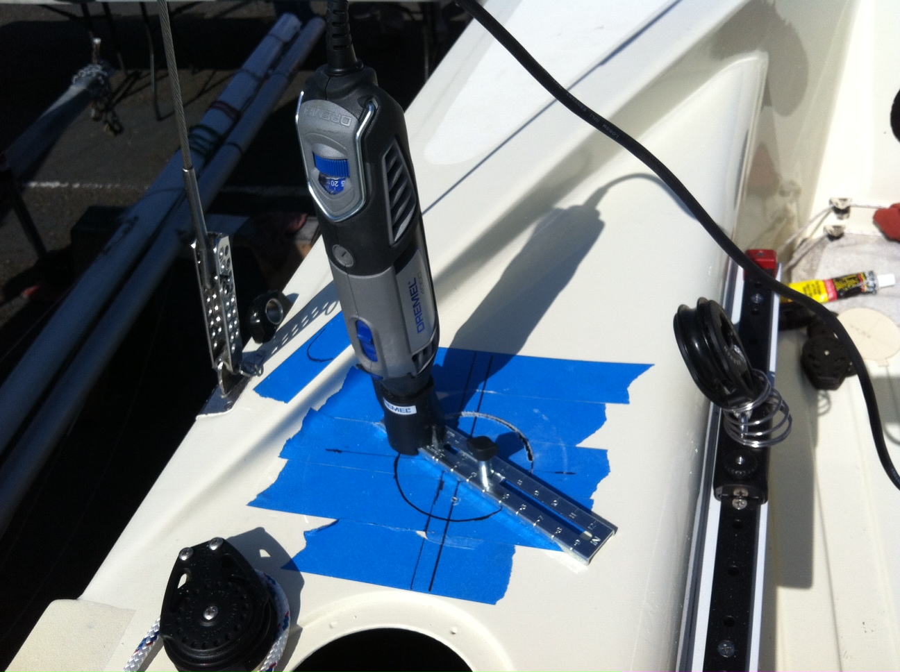 A close up of an electric screwdriver on the side of a boat.