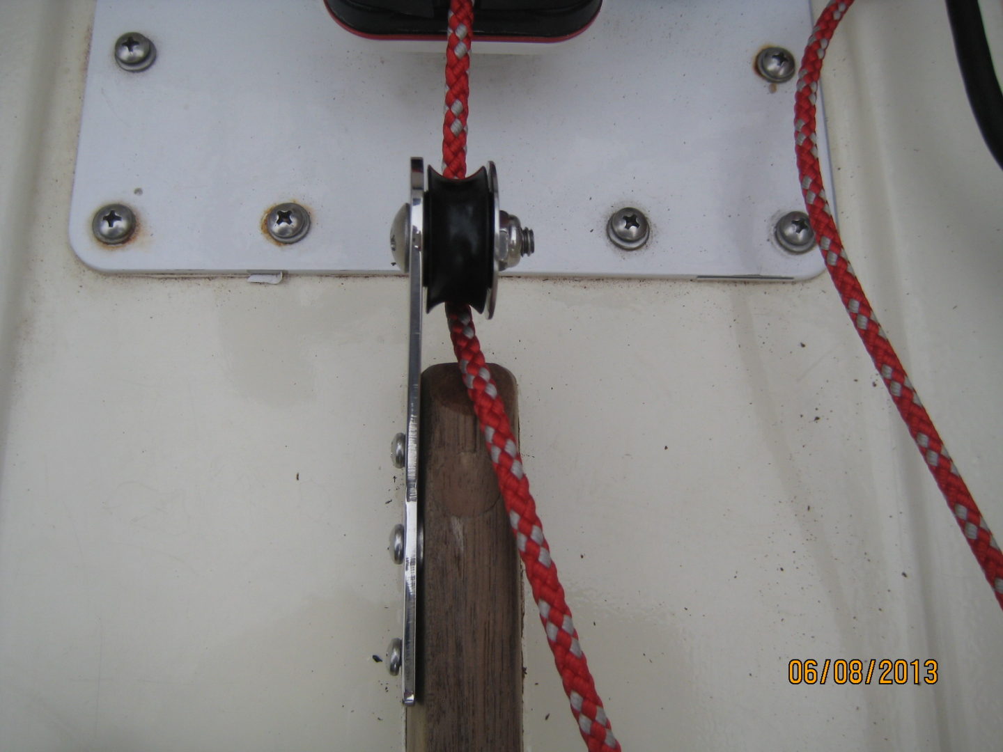 A red rope is tied to the side of a boat.