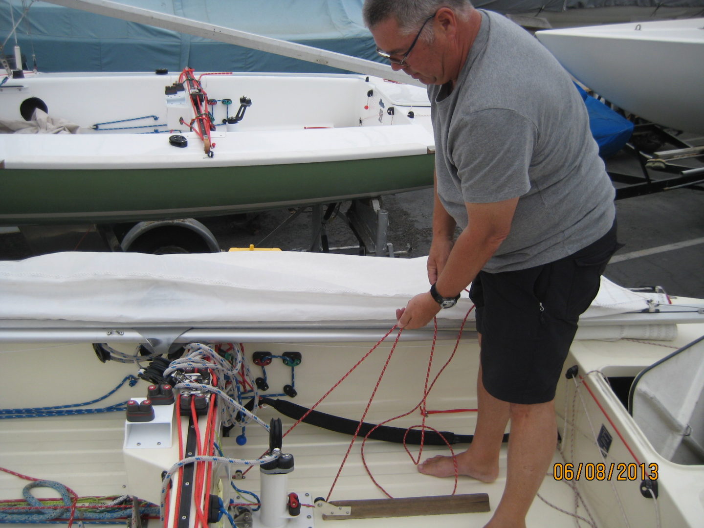 A man is tying up his boat on the dock.