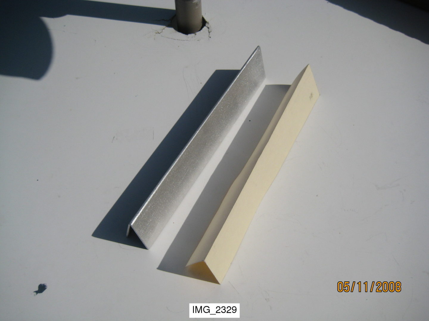 A white and yellow plastic shelf on top of a table.