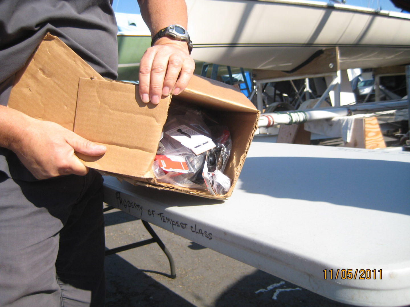 A person holding an open box of food.