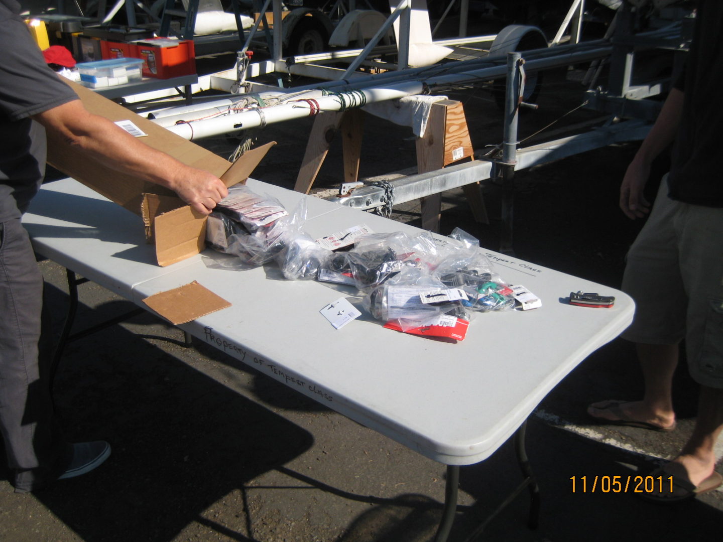 A person is holding onto some boxes on the table