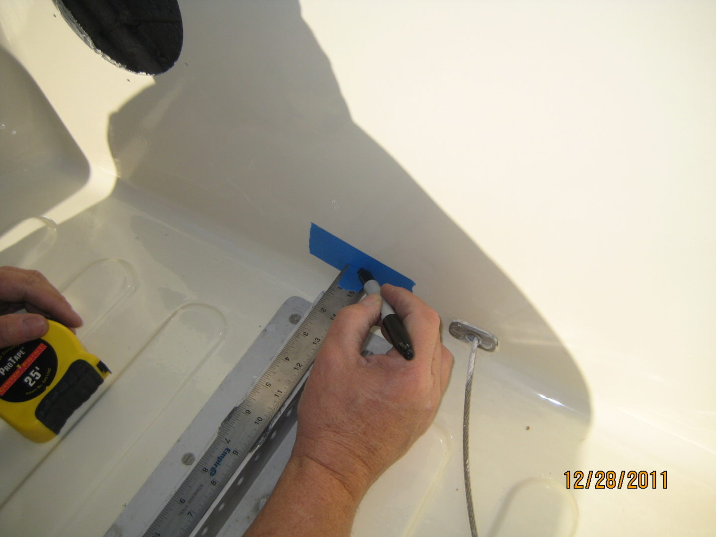 A person is working on the ceiling of a bathroom.