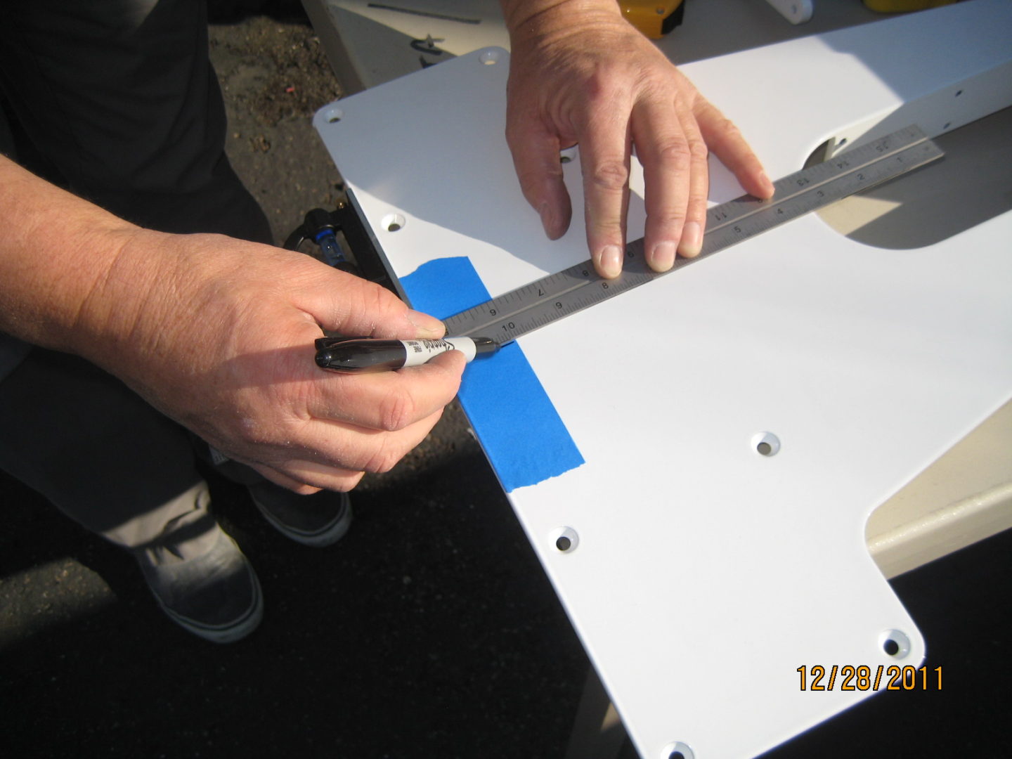 A person cutting something with a knife and a pen.