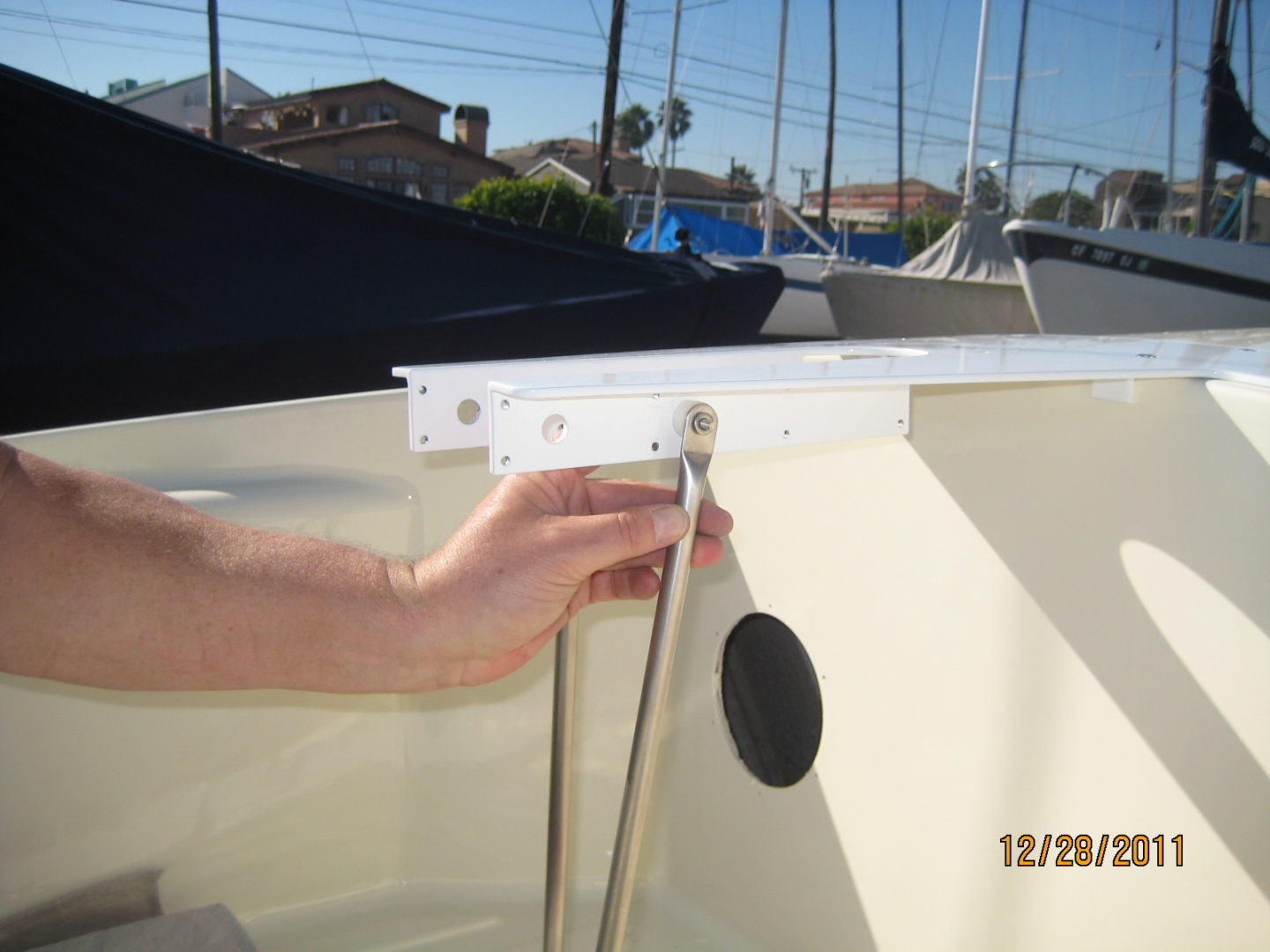 A hand holding the side of a boat.