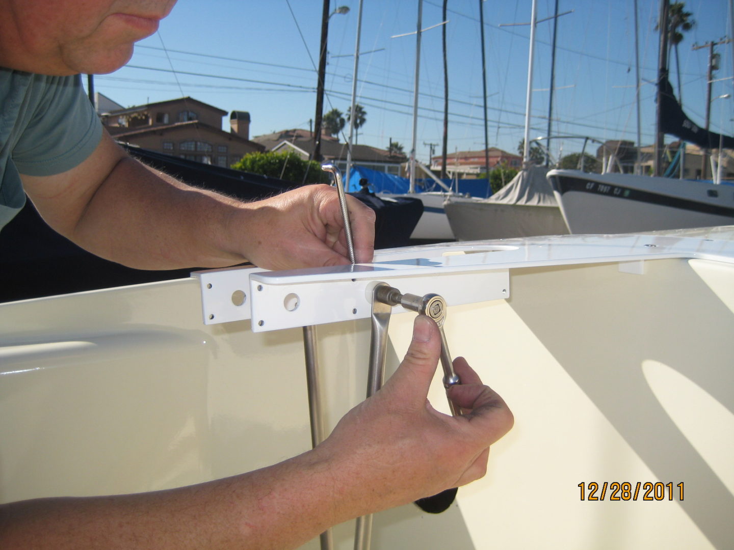 A man is fixing the sail on a boat.