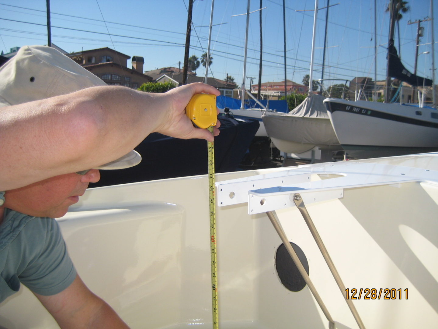 A man measuring the length of a boat.