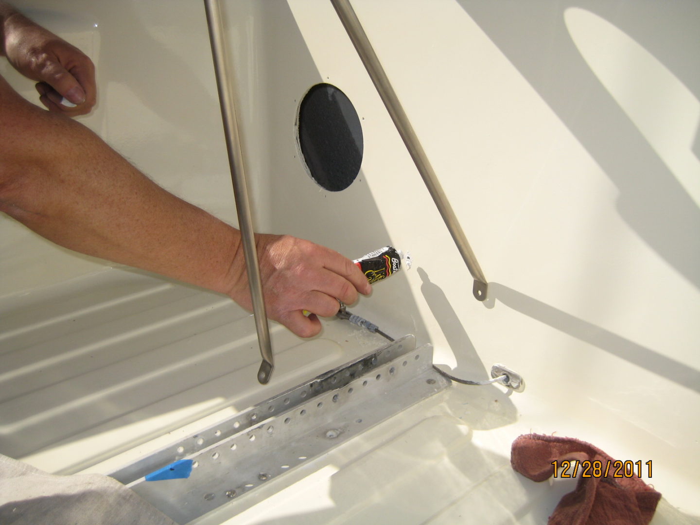 A person is working on the bottom of a boat.