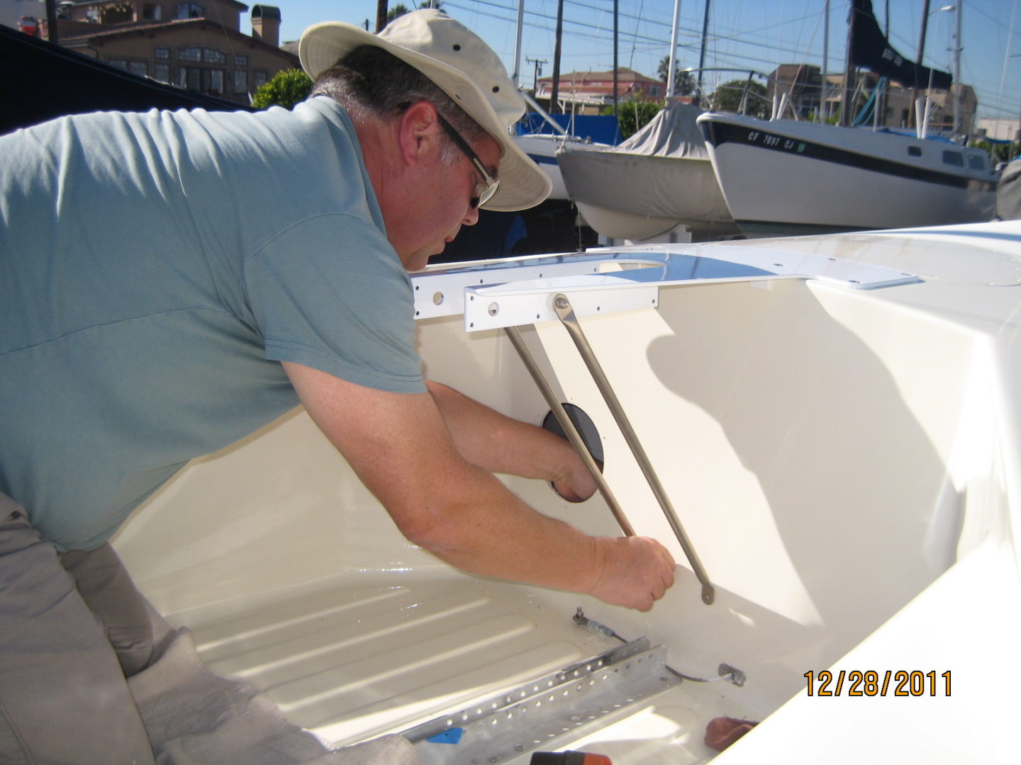 A man working on the side of a boat.