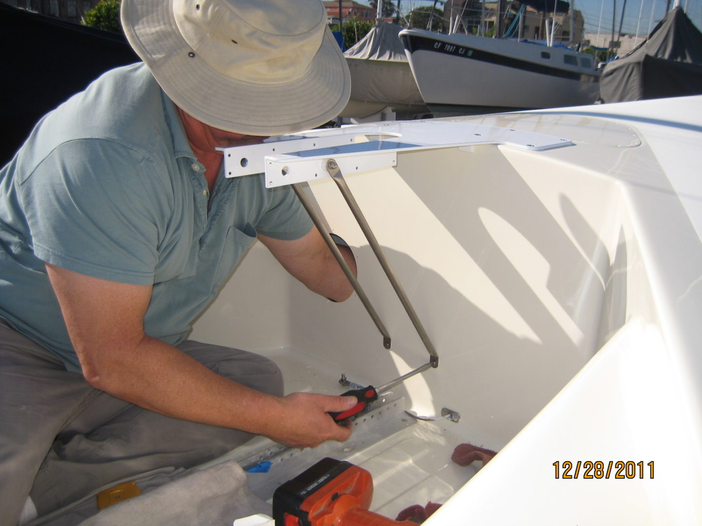 A man working on the side of a boat.