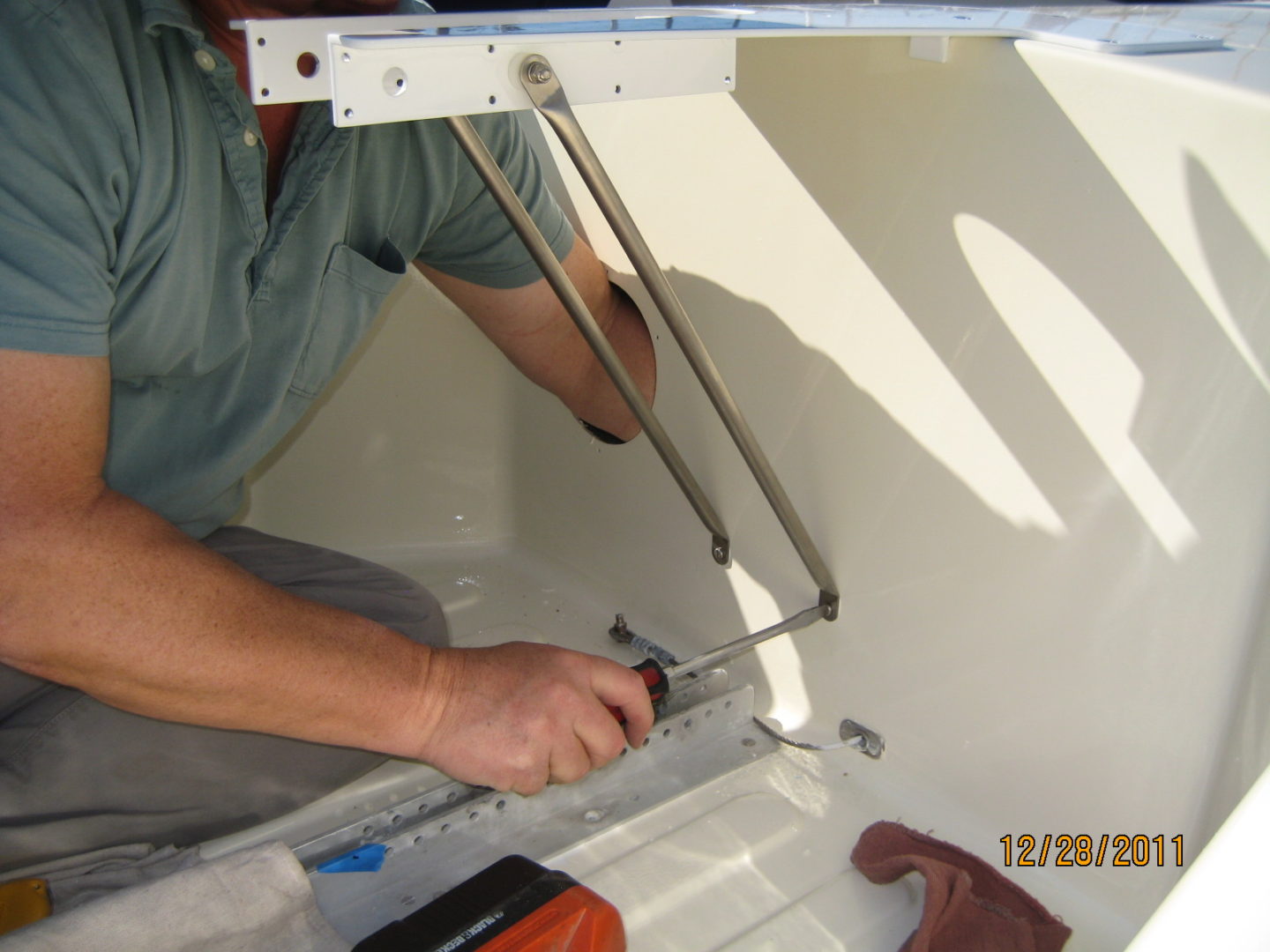 A man working on the outside of a boat.