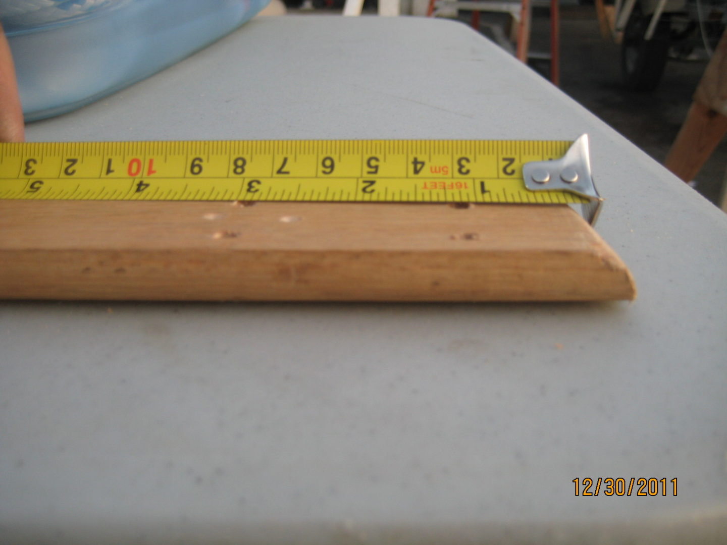 A wooden ruler with a yellow scale on it