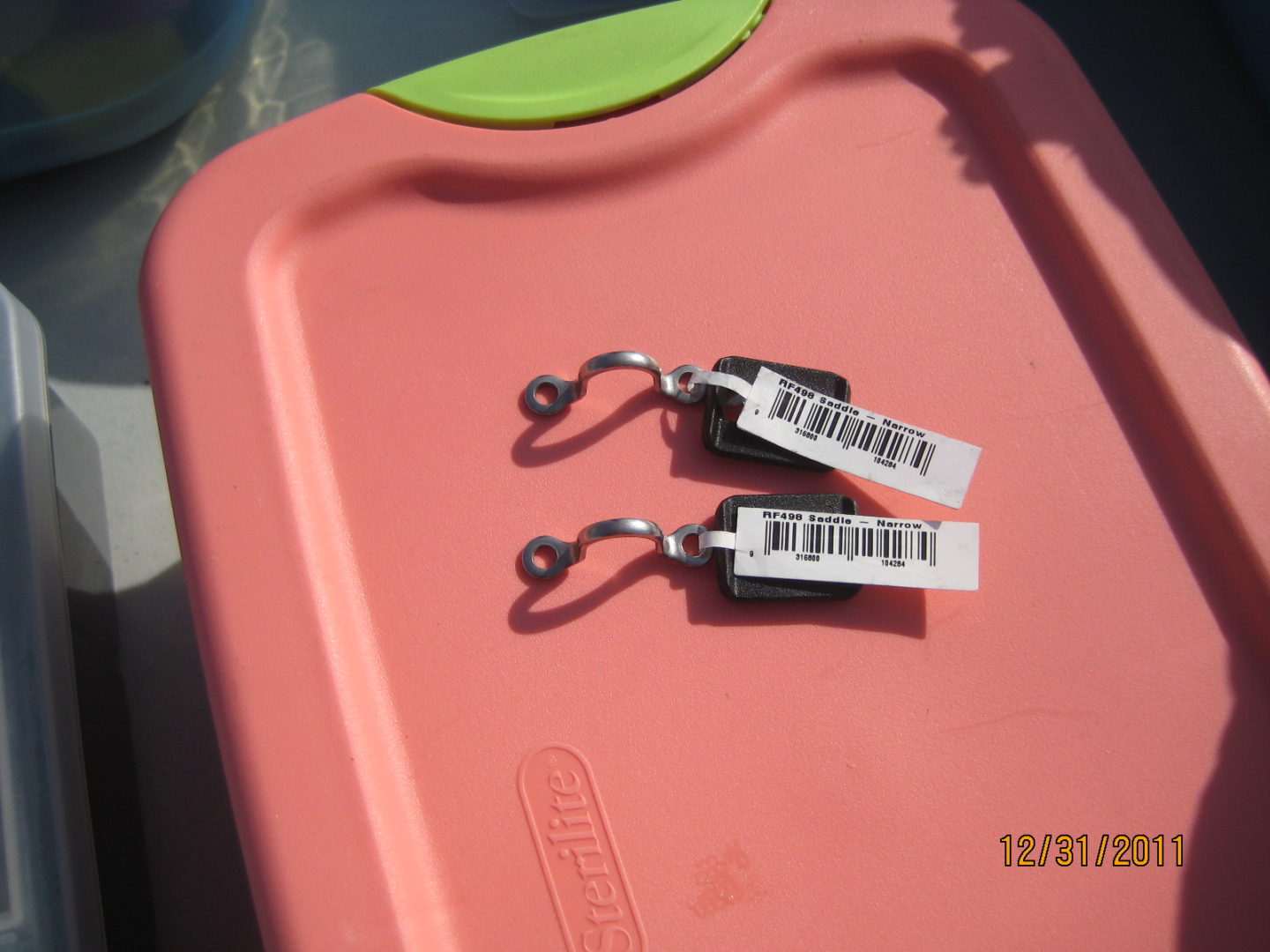 A pair of tags on top of a pink tray.