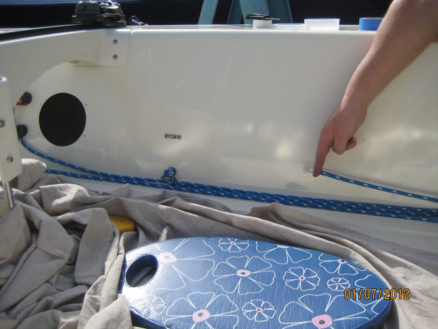 A blue and white surfboard sitting on top of the ground.