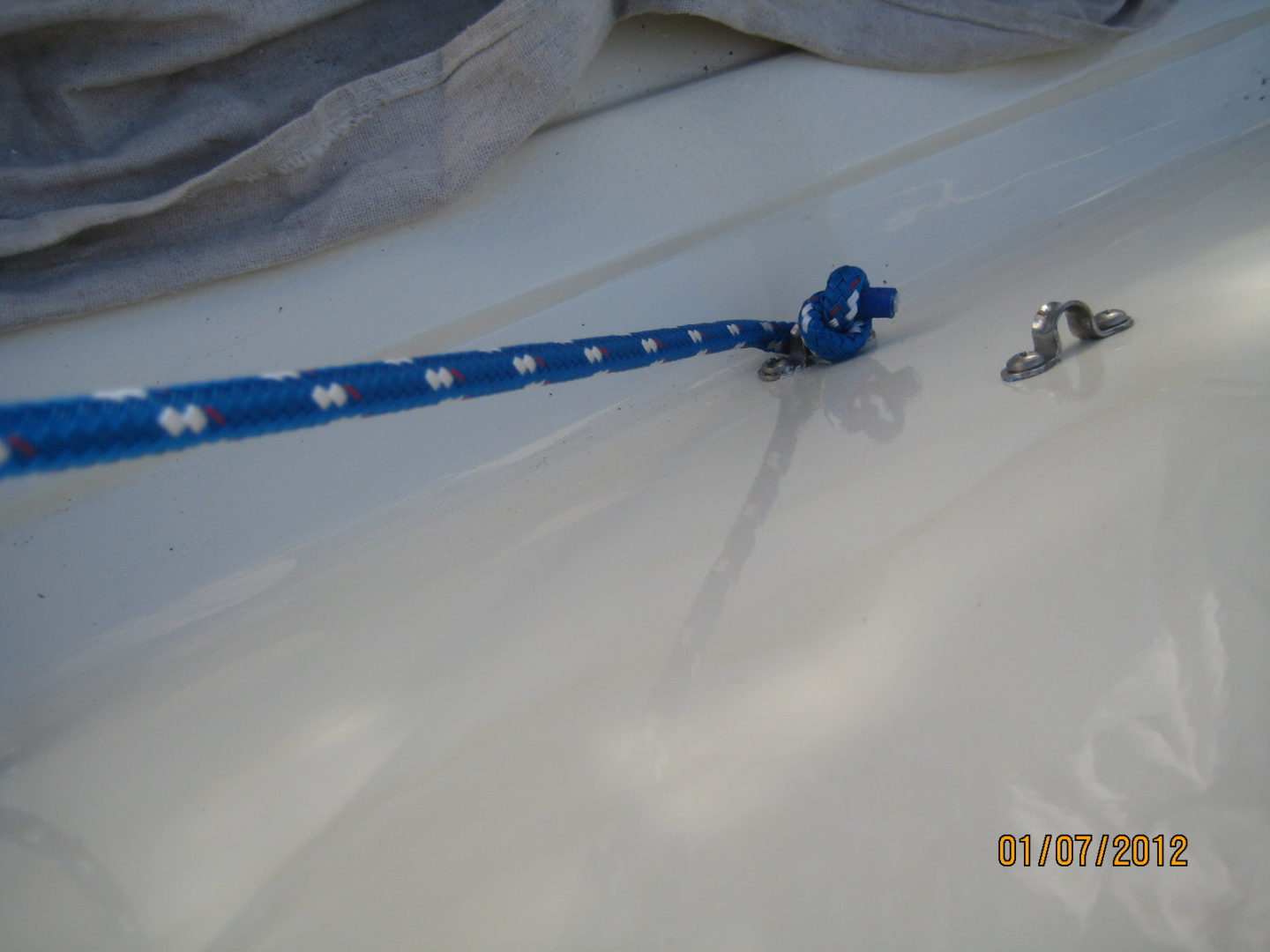 A blue and white ski pole on the snow.