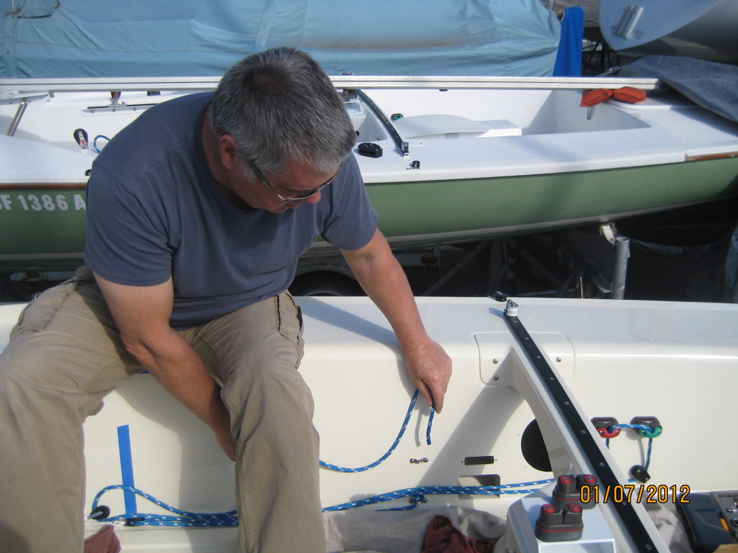 A man working on the side of a boat.