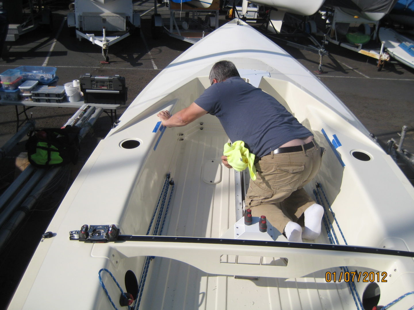 A man is working on the side of a boat.