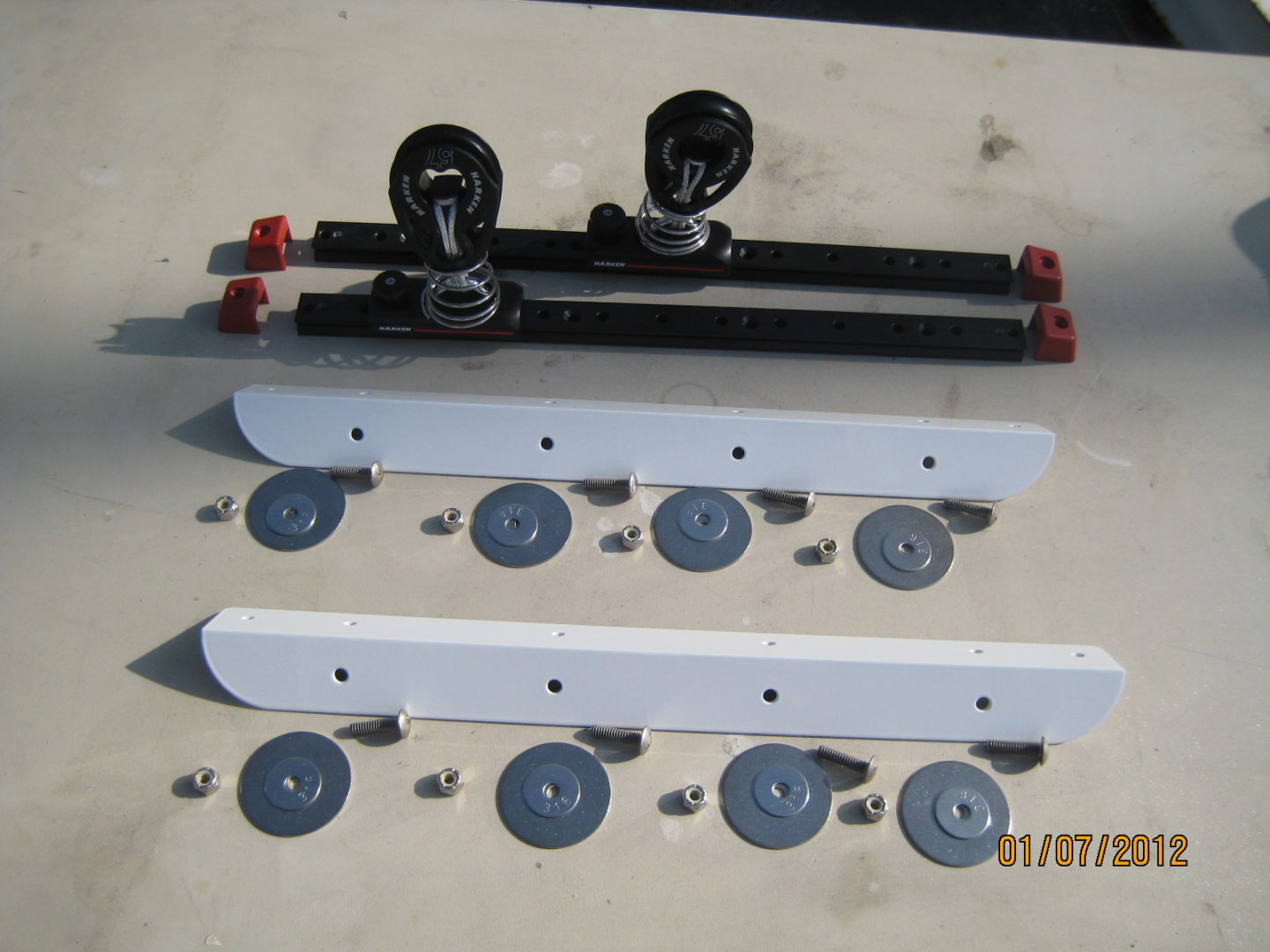 A pair of black and white plastic handles next to some metal wheels.