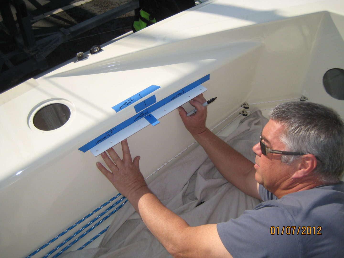 A man is working on the back of a boat.